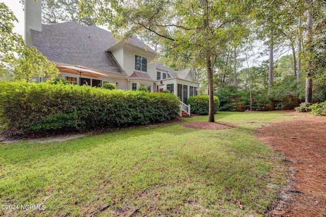 view of yard featuring a sunroom