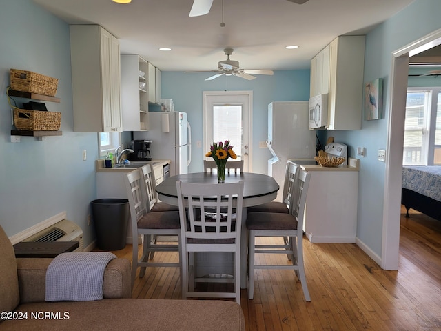 2712 Island Dr, North Topsail Beach, NC 28460 - dining room featuring light wood-style floors, baseboards, and a ceiling fan
