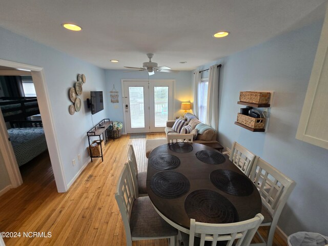 dining room with ceiling fan and light hardwood / wood-style floors