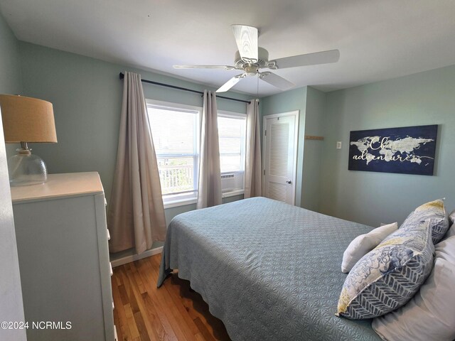 bedroom with ceiling fan, a closet, and wood-type flooring