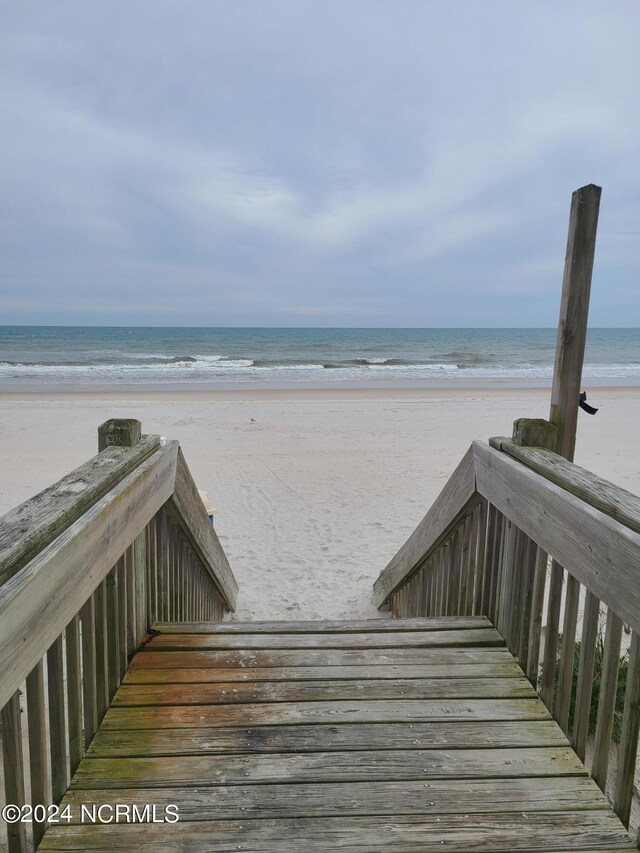 exterior space featuring a beach view and a water view