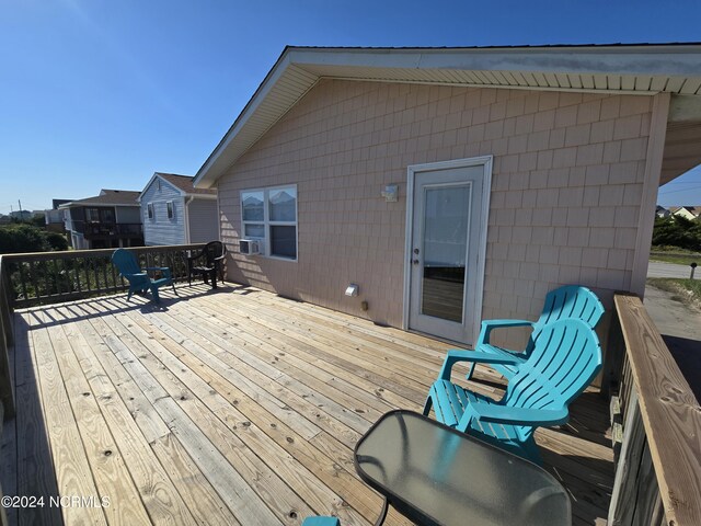 wooden terrace featuring cooling unit