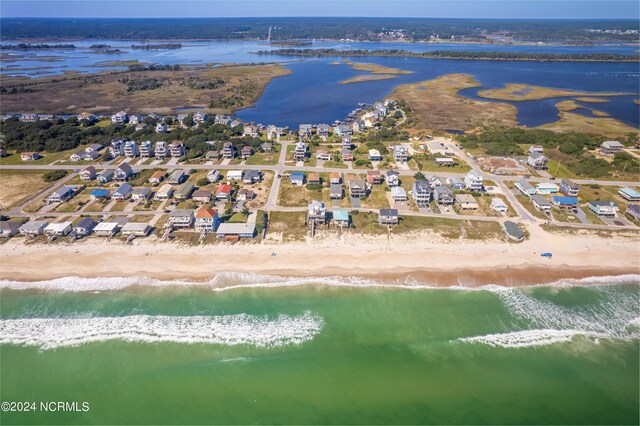 birds eye view of property featuring a water view and a beach view