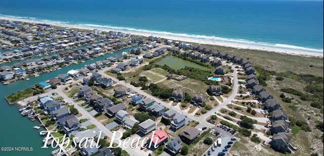 drone / aerial view featuring a water view and a beach view