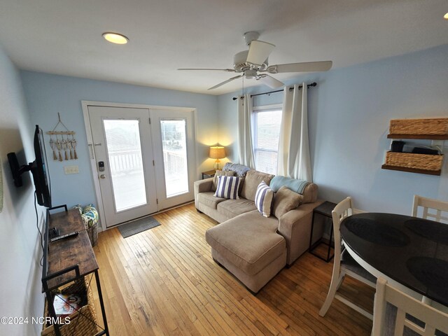 living room with light wood-type flooring and ceiling fan