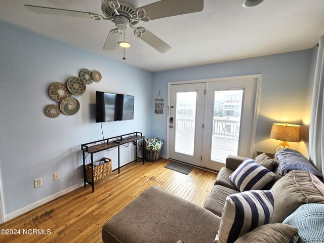 living room featuring ceiling fan and light hardwood / wood-style floors