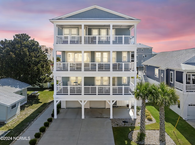 view of front of house featuring a balcony and a yard