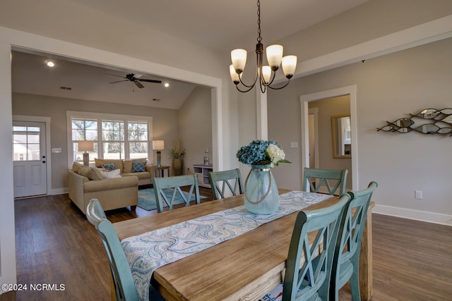 dining space featuring ceiling fan with notable chandelier and dark wood-type flooring