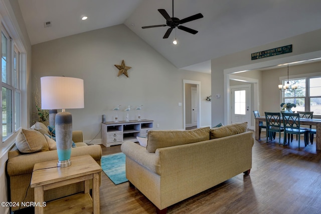 living room with ceiling fan with notable chandelier, wood-type flooring, and high vaulted ceiling