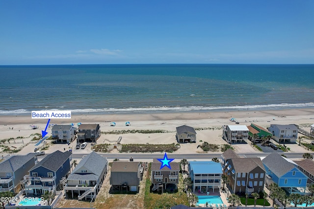 birds eye view of property featuring a water view and a view of the beach