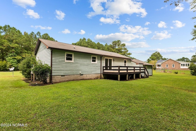 back of house featuring a yard and a deck