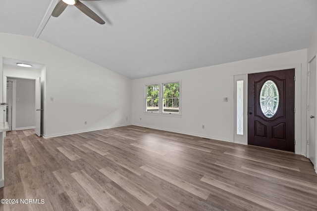 foyer entrance featuring lofted ceiling, ceiling fan, and light hardwood / wood-style flooring