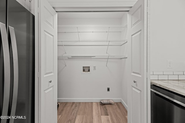 laundry room featuring light hardwood / wood-style floors and hookup for a washing machine