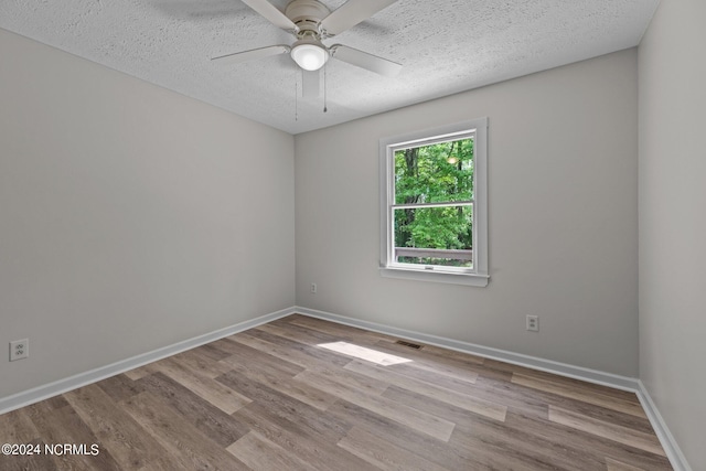 spare room featuring ceiling fan, a textured ceiling, and light hardwood / wood-style floors