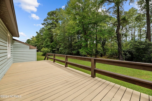 wooden deck featuring a yard