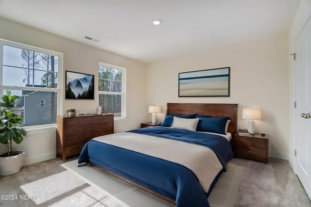 bedroom featuring light carpet