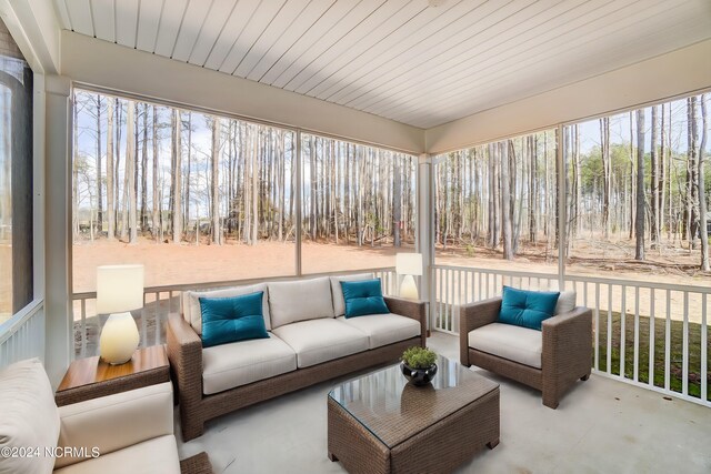 sunroom featuring wood ceiling