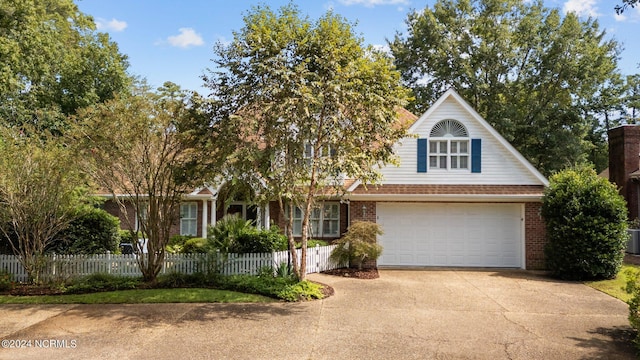 view of front of home featuring a garage and central AC