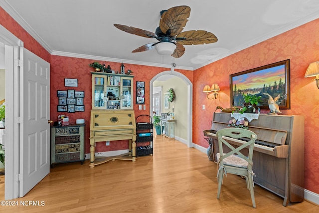 interior space featuring crown molding, wood-type flooring, and ceiling fan