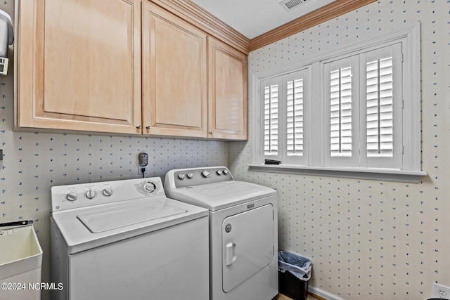 laundry room with cabinets, washer and clothes dryer, and ornamental molding