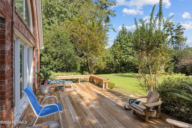 wooden deck featuring a yard