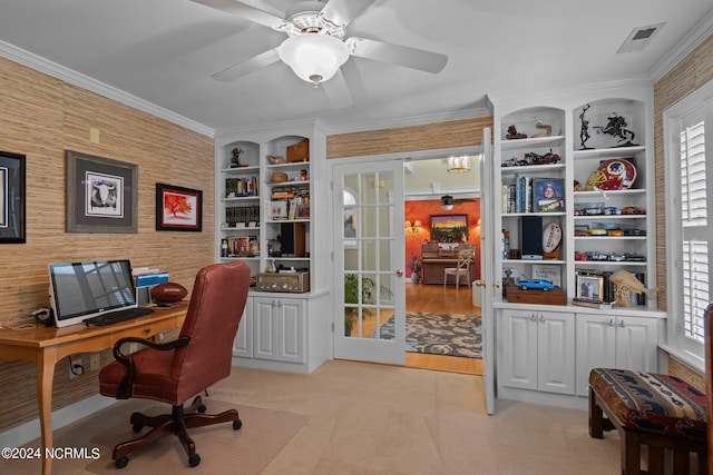 carpeted office space featuring crown molding and ceiling fan