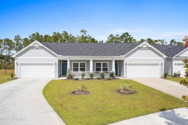 single story home with driveway, a front lawn, and a porch