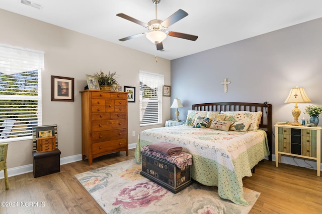 bedroom with visible vents, ceiling fan, light wood-style flooring, and baseboards