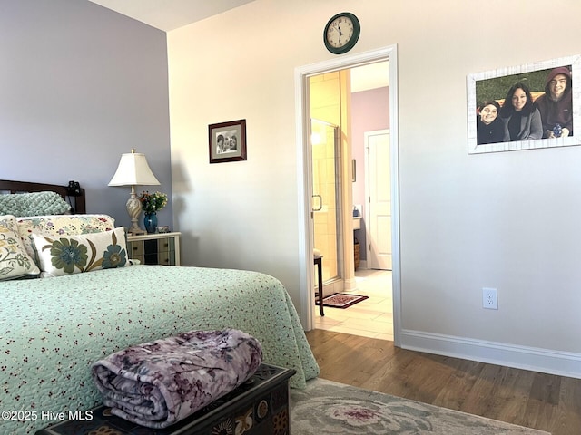 bedroom with baseboards and dark wood finished floors