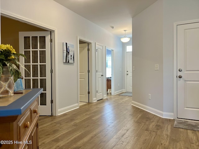 interior space featuring baseboards and wood finished floors