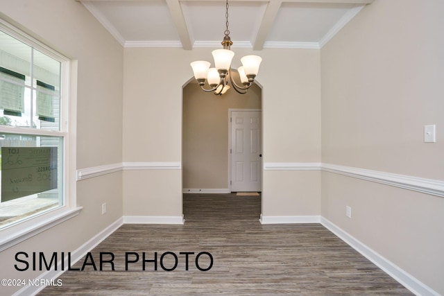 spare room with an inviting chandelier, beam ceiling, dark hardwood / wood-style flooring, and crown molding