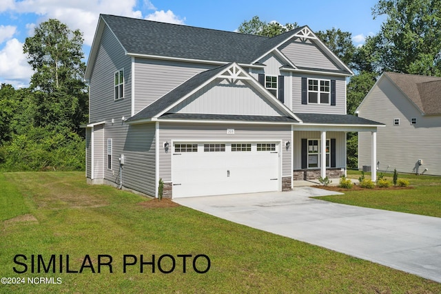 craftsman inspired home featuring a front yard and a garage