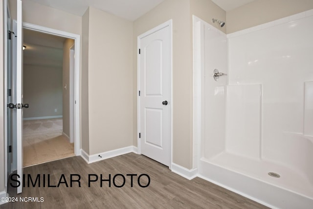 bathroom featuring wood-type flooring and a shower