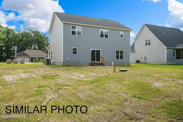 rear view of house featuring a lawn