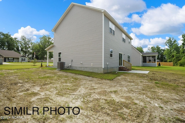 view of side of property with a lawn and central air condition unit