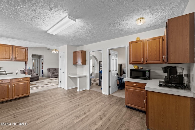 kitchen featuring a textured ceiling and light wood-type flooring