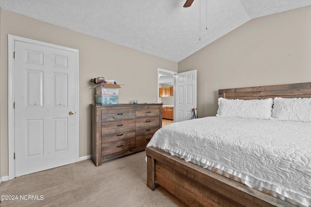 bedroom featuring vaulted ceiling, light carpet, ceiling fan, and a textured ceiling