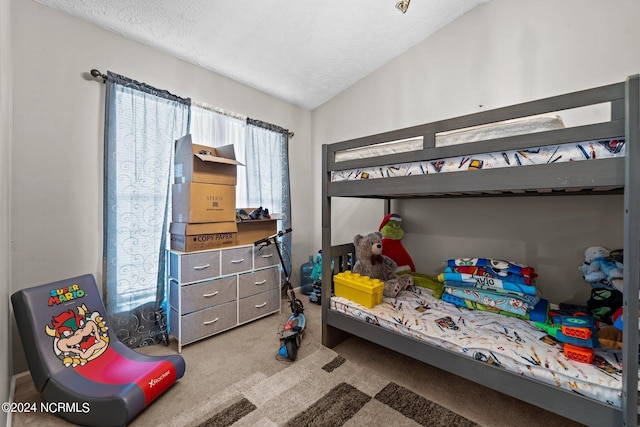 bedroom featuring lofted ceiling, carpet flooring, and a textured ceiling