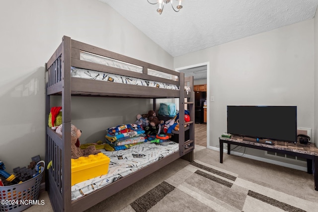 carpeted bedroom featuring vaulted ceiling and a textured ceiling