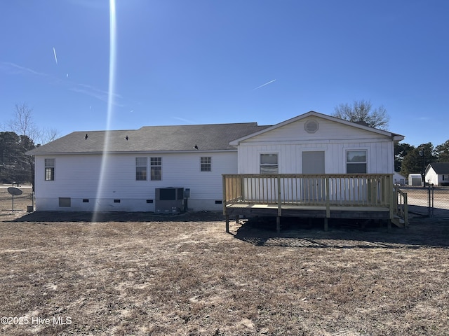 rear view of house featuring cooling unit and a deck