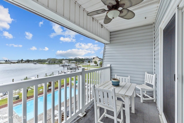 balcony with a water view and ceiling fan