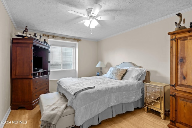 bedroom featuring ornamental molding, light hardwood / wood-style floors, ceiling fan, and a textured ceiling