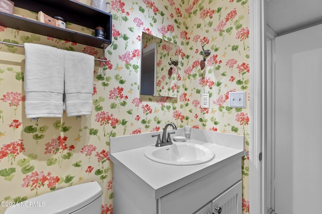 bathroom featuring vanity and toilet