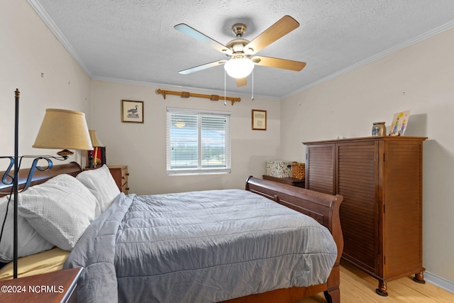 bedroom with ceiling fan, a textured ceiling, light hardwood / wood-style flooring, and crown molding