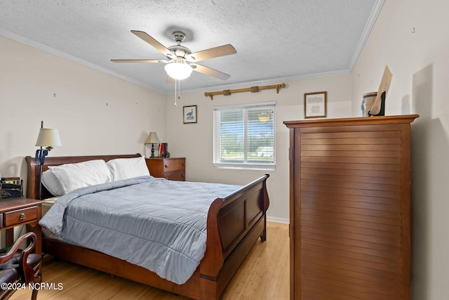 bedroom featuring light hardwood / wood-style flooring, ceiling fan, ornamental molding, and a textured ceiling