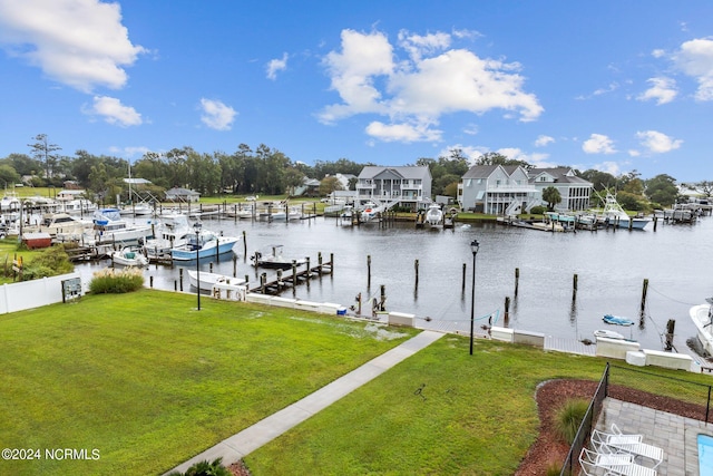 view of dock featuring a water view and a yard