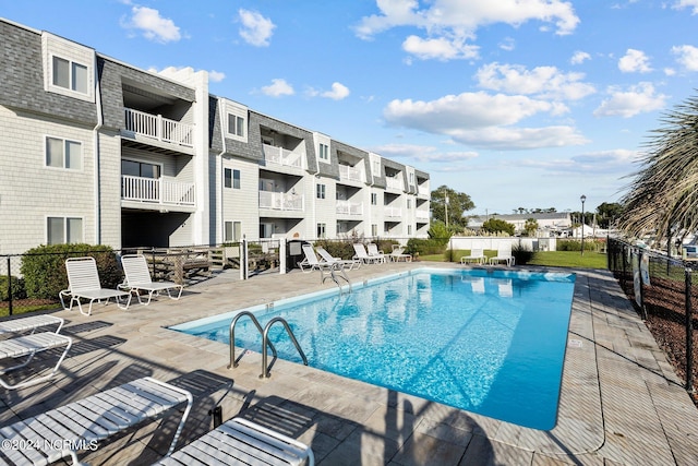 view of swimming pool featuring a patio area