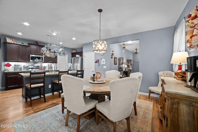 dining room featuring sink and light hardwood / wood-style flooring