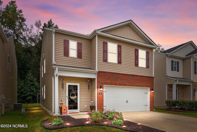 view of front of property featuring cooling unit and a garage