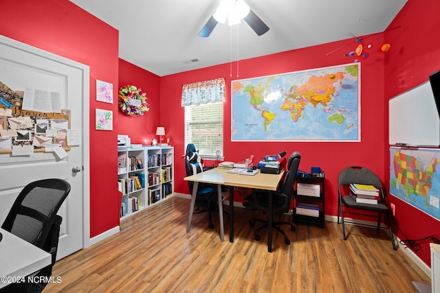 home office with hardwood / wood-style floors and ceiling fan